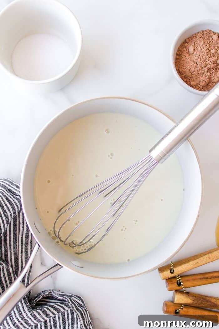 A small saucepan on a stovetop, gently heating dairy-free milk.