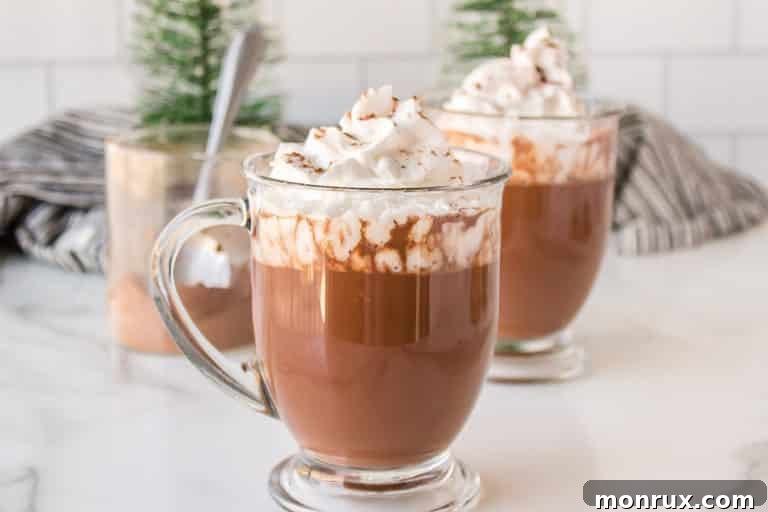 A warm mug of oat milk hot chocolate, perfectly presented on a wooden table, invitingly steamy and ready to be enjoyed.