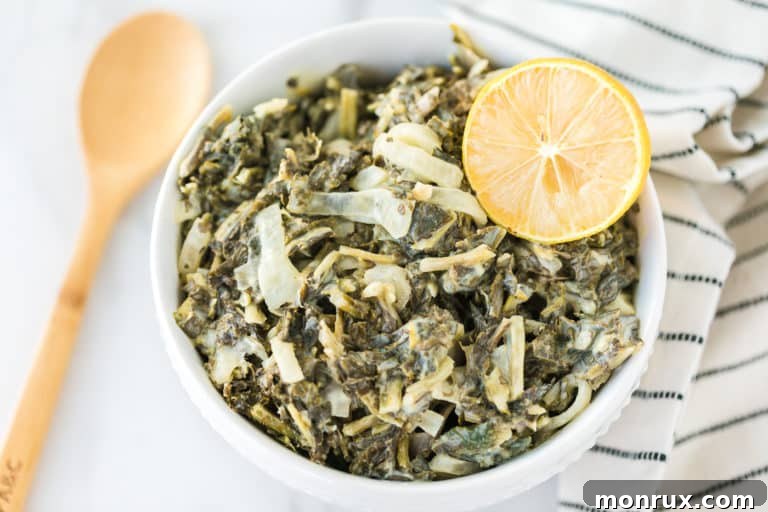 A bowl of hot, creamy vegan kale, perfectly seasoned and ready to be enjoyed as a wholesome side dish.