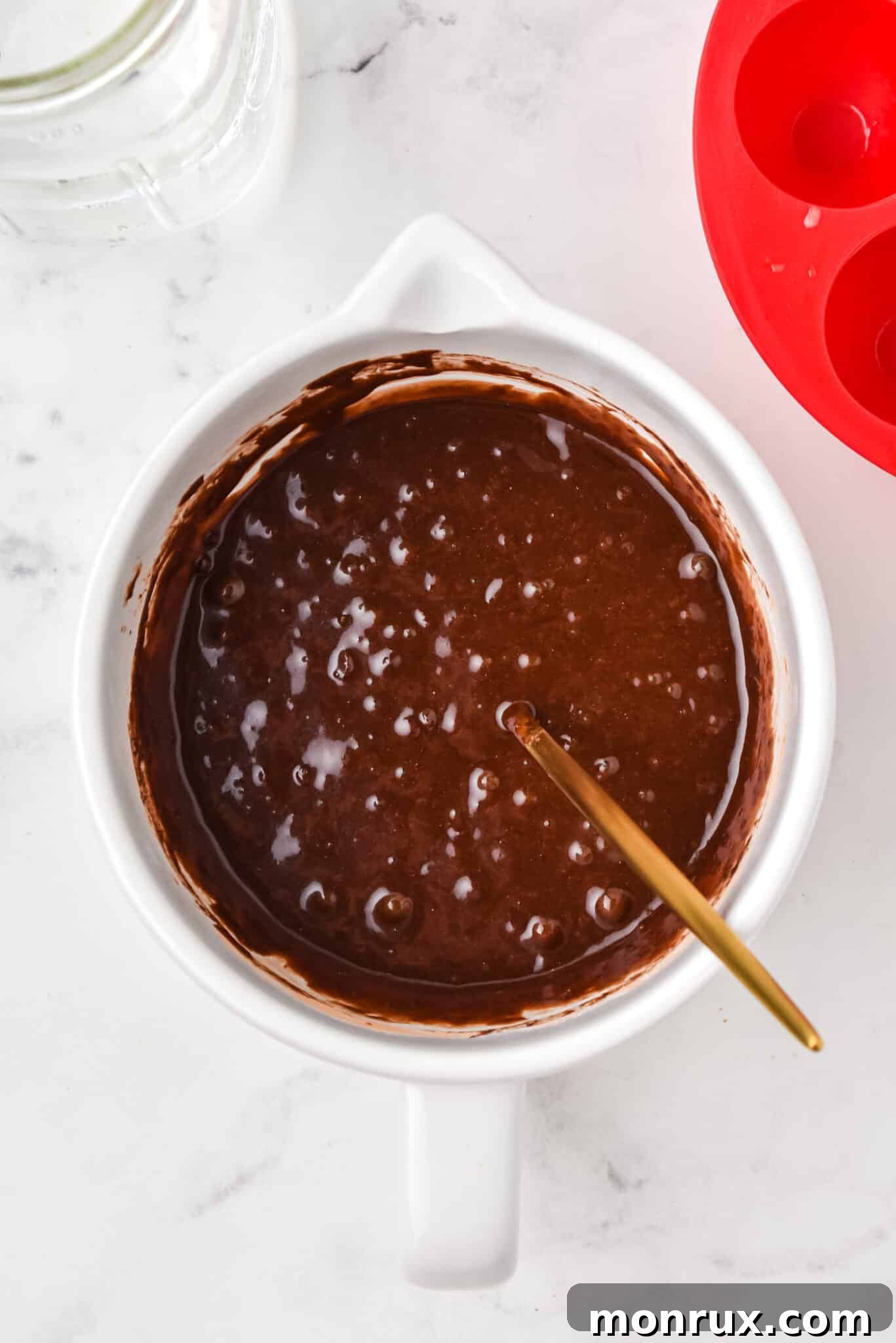 Fully combined batter for instant pot brownie bites in a mixing bowl.