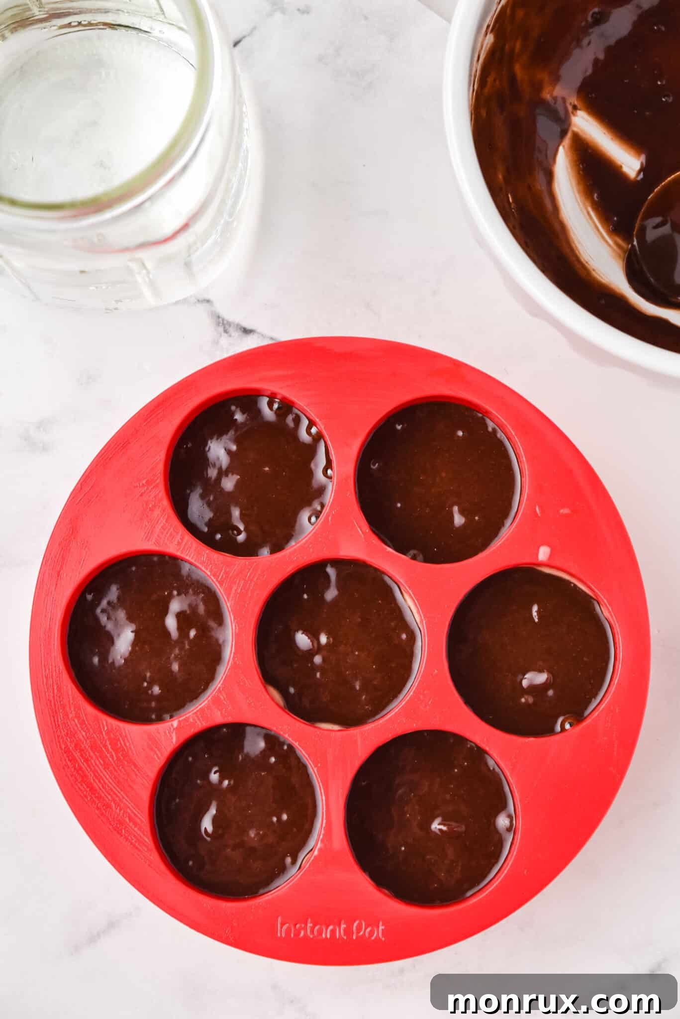 Instant pot brownie bite batter carefully spooned into a silicone egg mold.