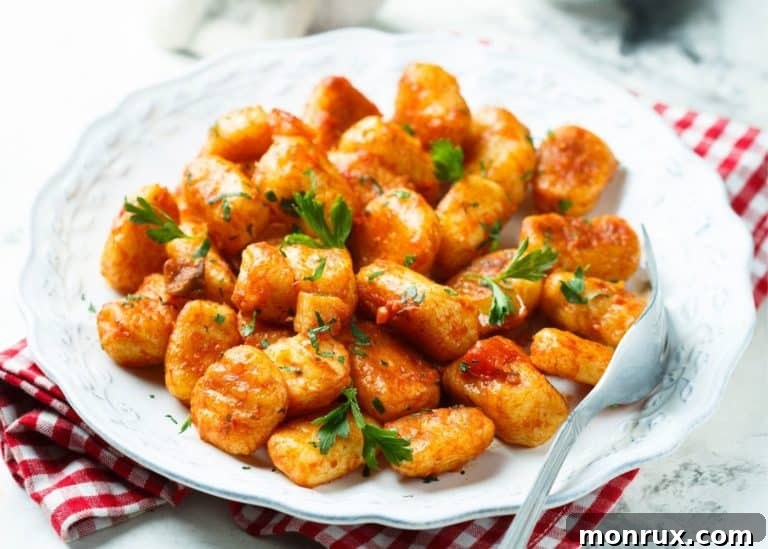 Delicious gluten-free gnocchi ready to eat, served on a white plate with sauce.