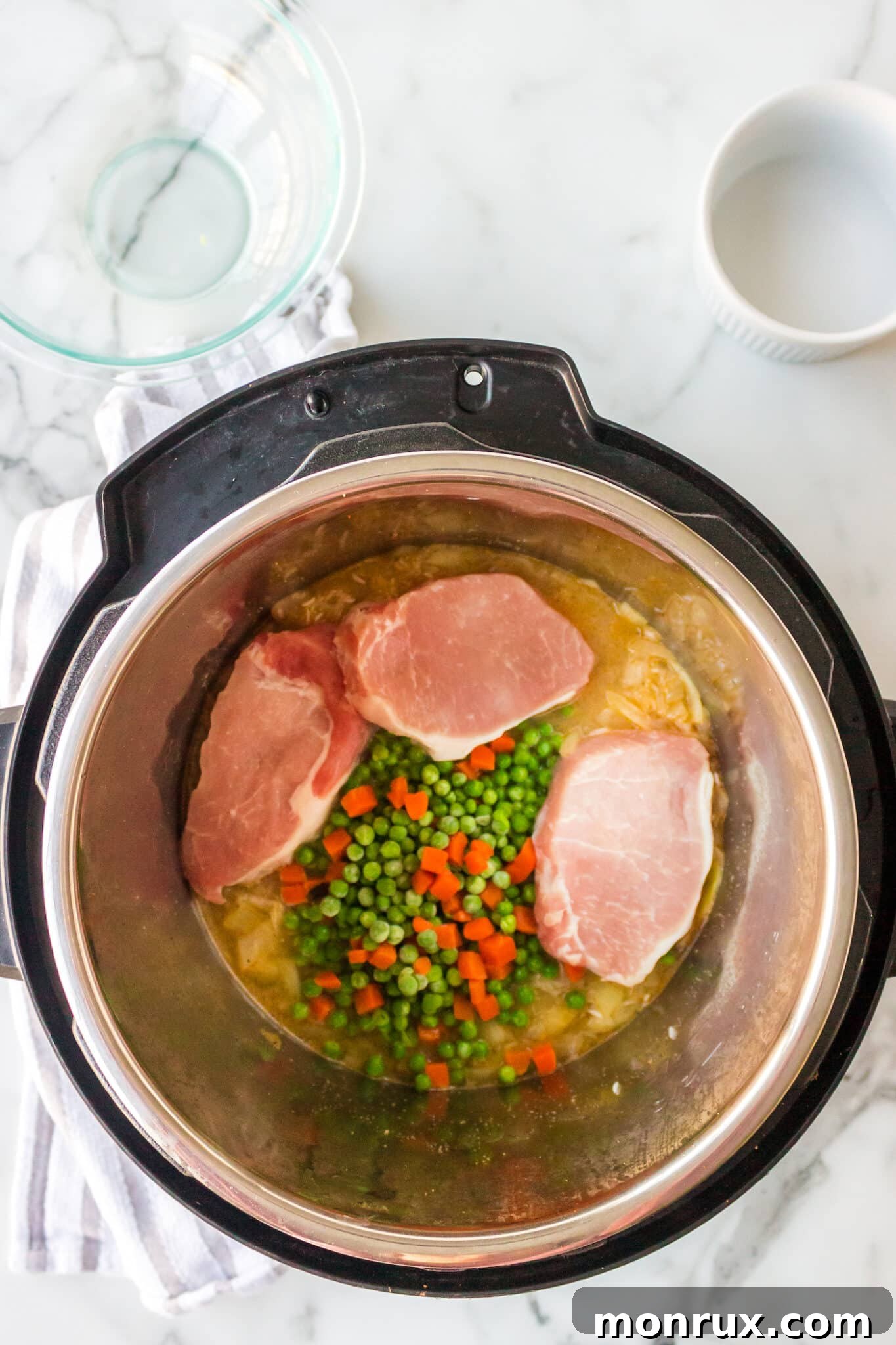 ingredients for pork chops and rice inside instant pot.