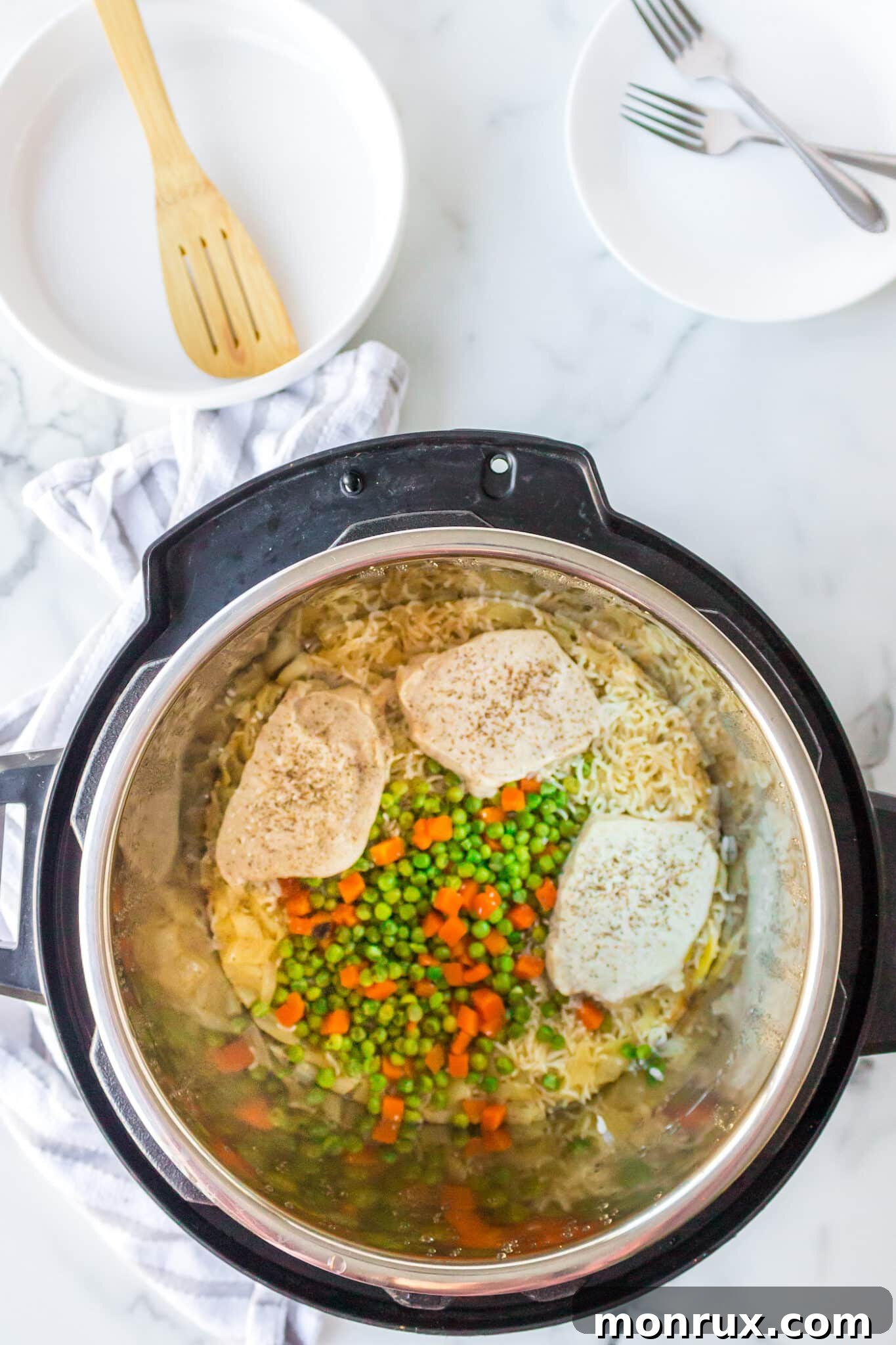 cooked pork chops and rice with veggies inside instant pot.