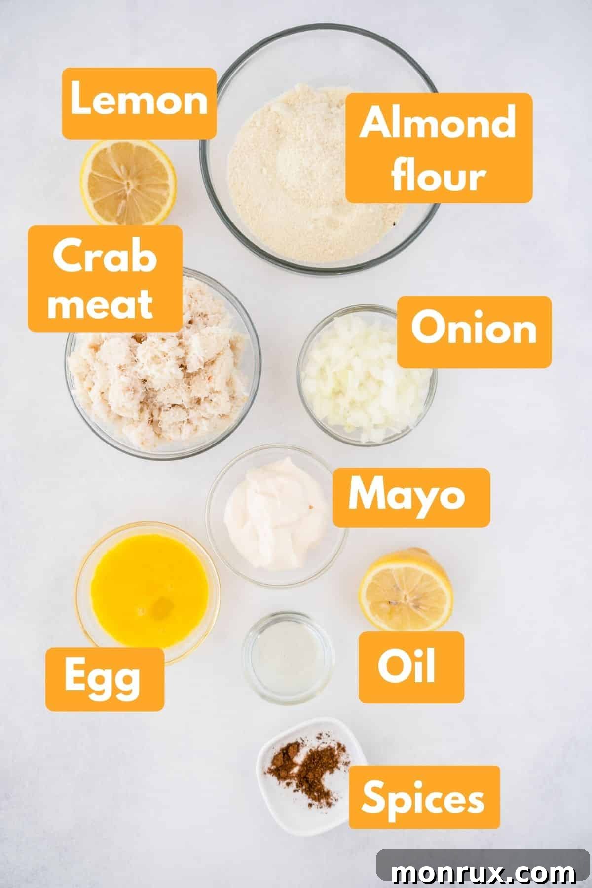 Ingredients with labels for making gluten-free and Whole30 crab cakes recipe, including canned crab, almond flour, mayonnaise, lemon, and spices.