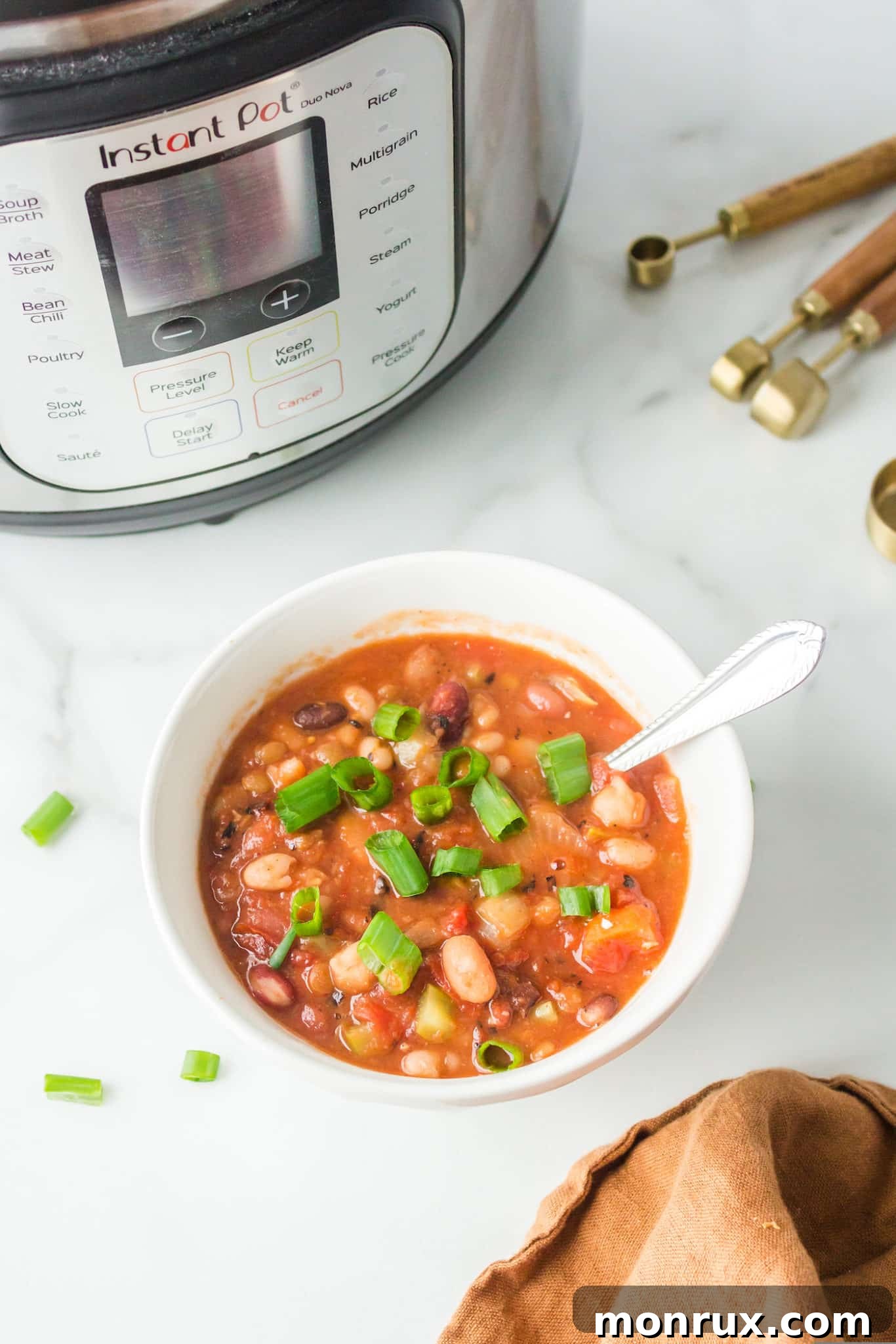 white bowl filled with cooked instant pot 15 bean soup ready to be enjoyed.