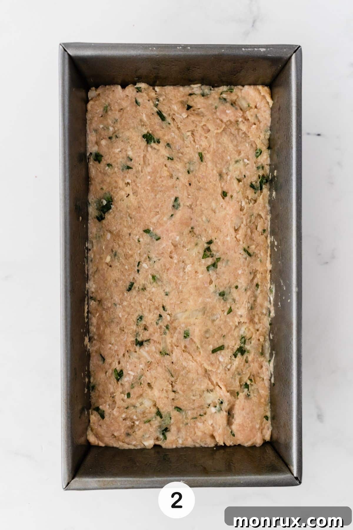 All meatloaf ingredients mixed thoroughly in a large bowl, ready to be transferred to the loaf pan.
