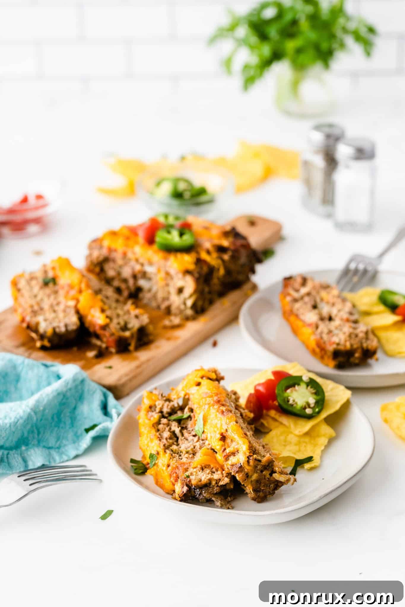 Table setting with serving plates of taco meatloaf, ready for dinner.