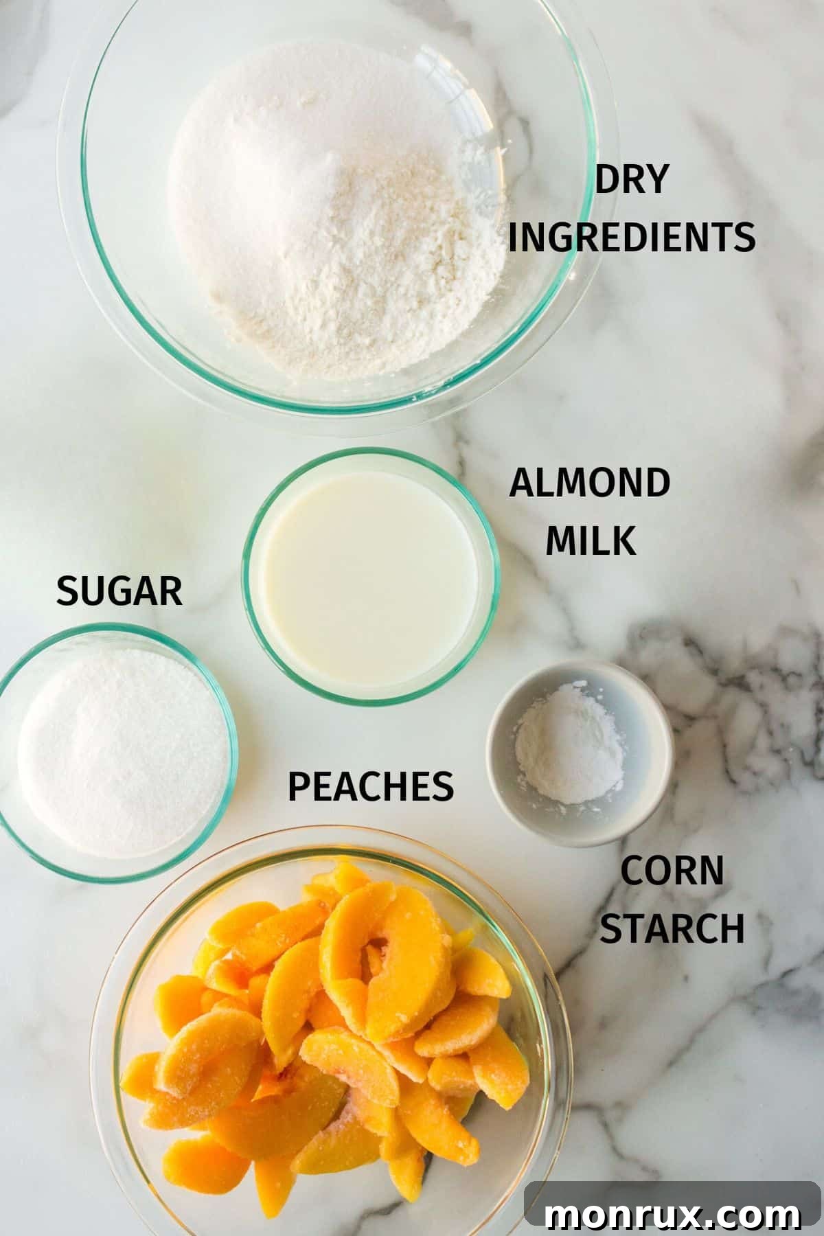 Ingredients for making almond flour peach cobbler, including frozen peaches, almond flour, sugar, and butter.