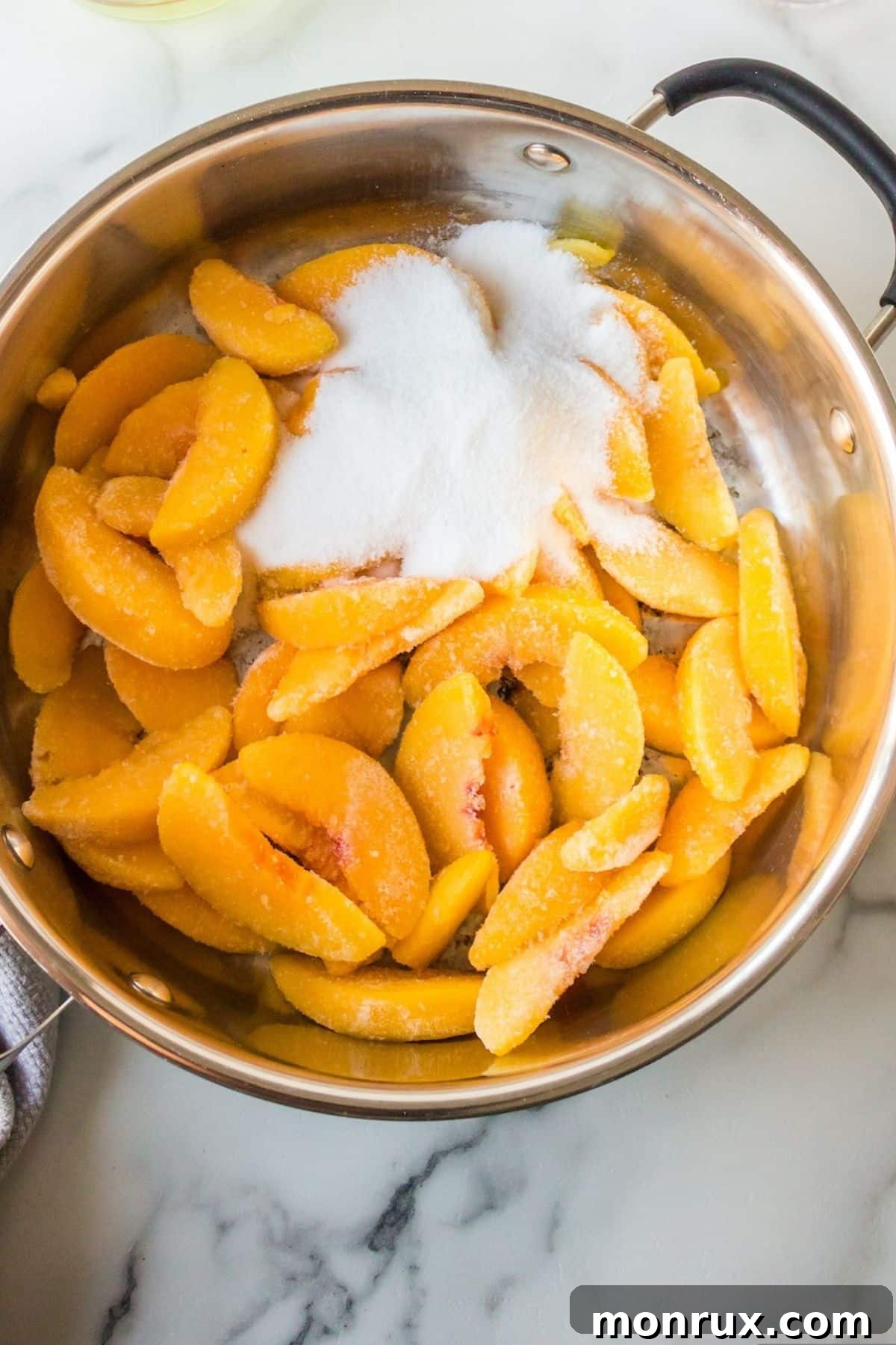 Step one: combining peaches, sugar, and cornstarch for the filling.