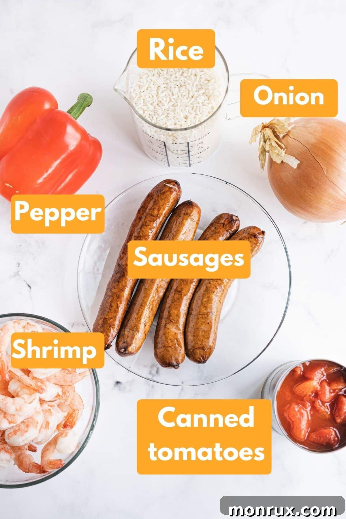 A vibrant spread of fresh ingredients for Instant Pot Jambalaya, including sausage, shrimp, rice, and colorful vegetables.