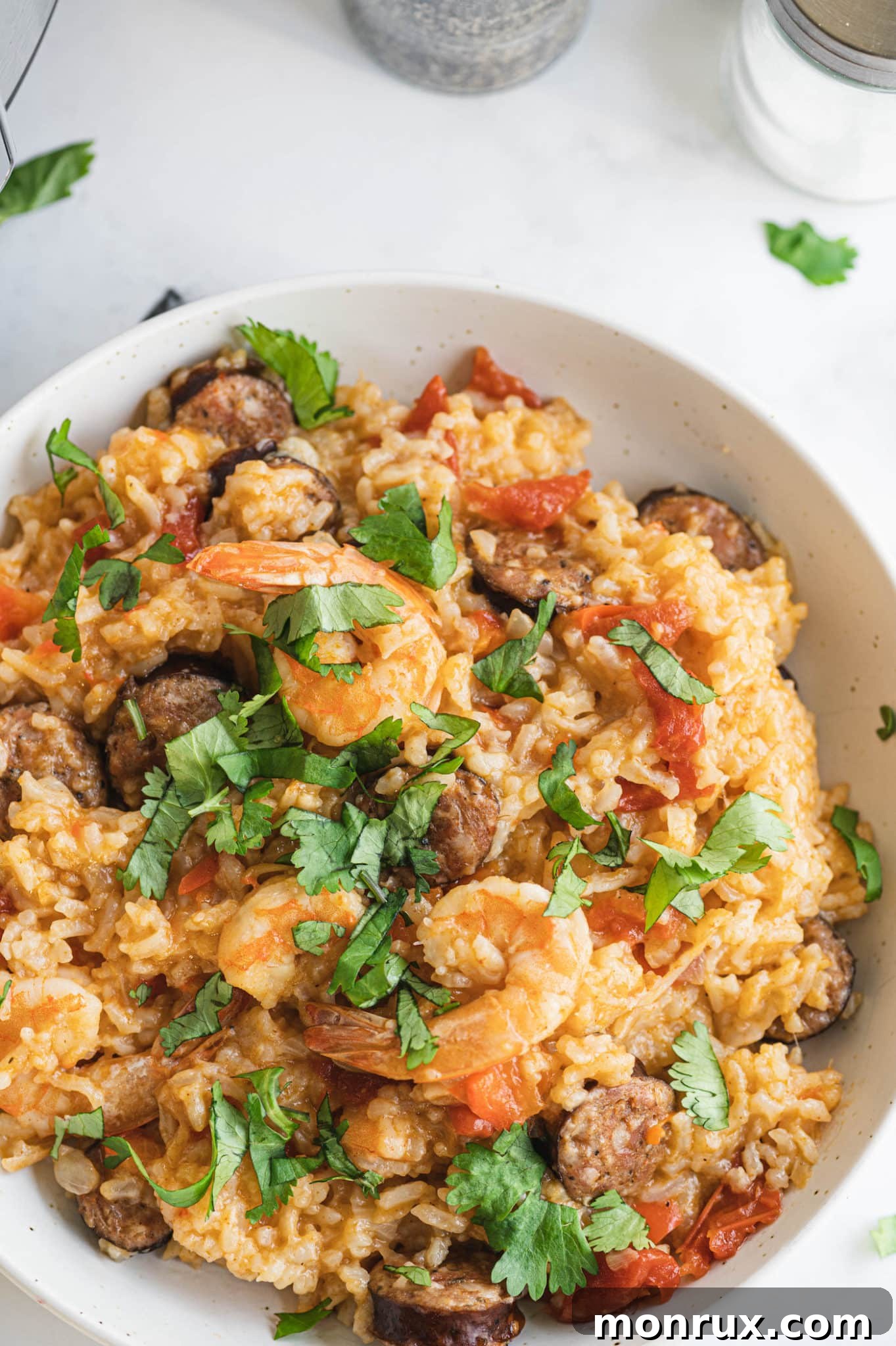 A close-up of a bowl of Instant Pot Jambalaya, showcasing the succulent shrimp and perfectly cooked rice.