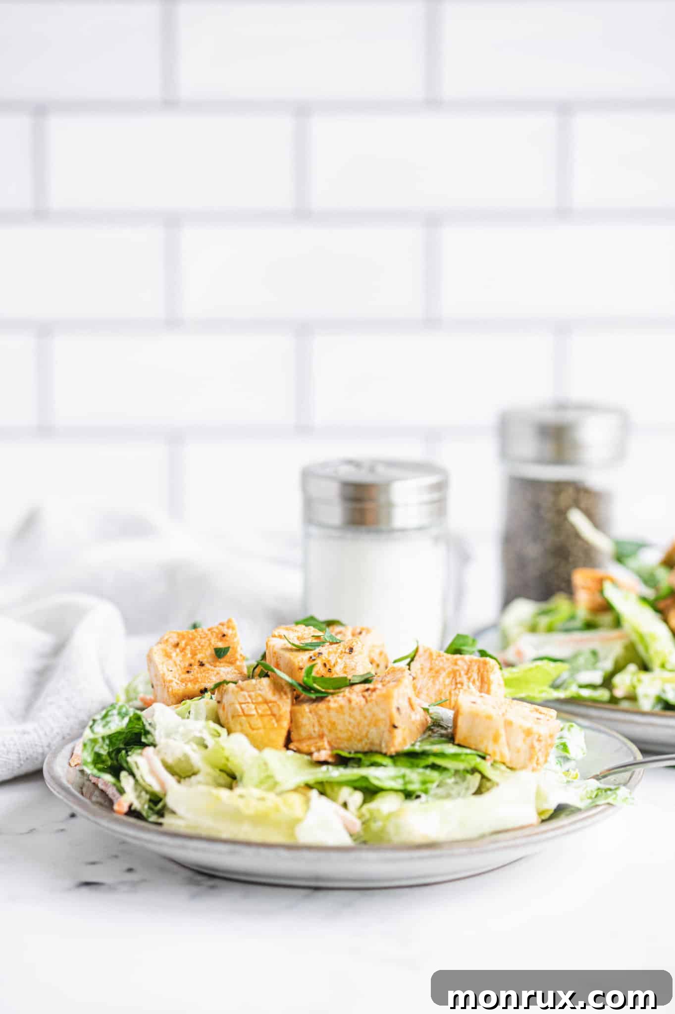A beautifully presented plate of Whole30 Buffalo Chicken Salad, garnished and ready to eat.