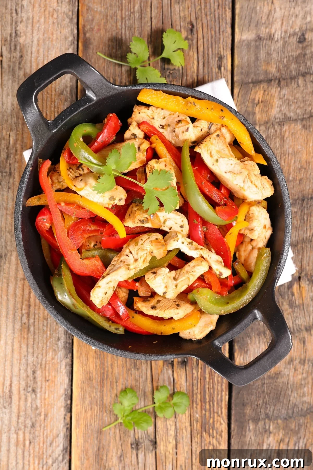 Sizzling low carb chicken fajitas served in a cast iron skillet, ready to eat.