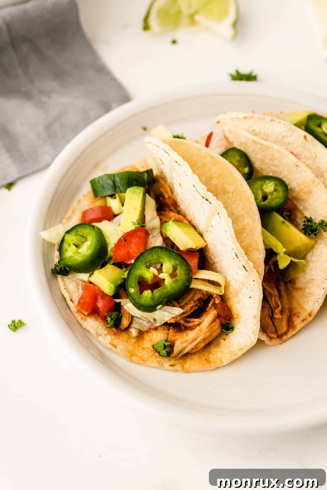 Chicken tinga instant pot tacos with avocado and jalapenos.