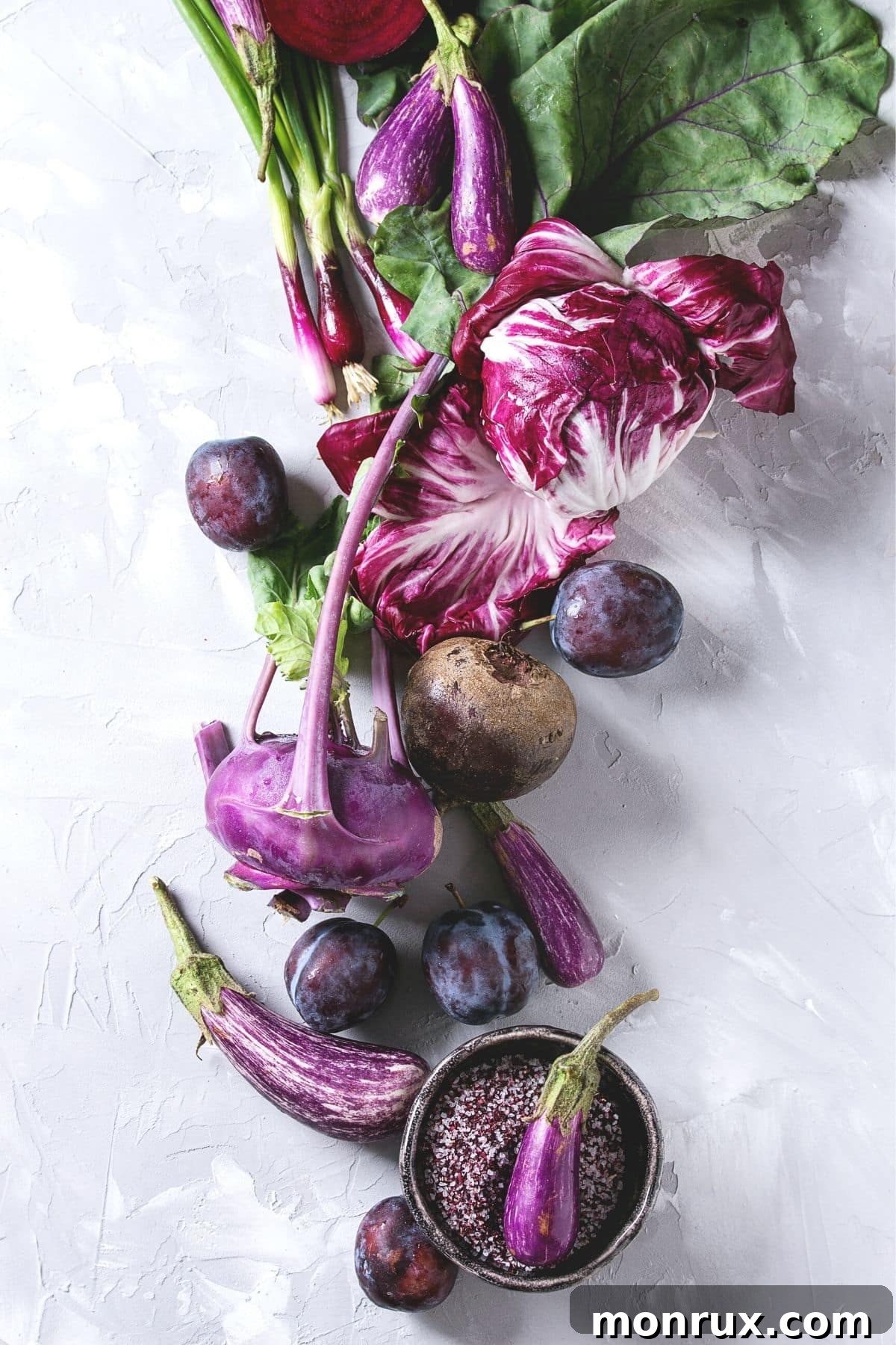 A vibrant selection of purple vegetables arranged on a tabletop, showcasing their natural beauty and inviting colors.