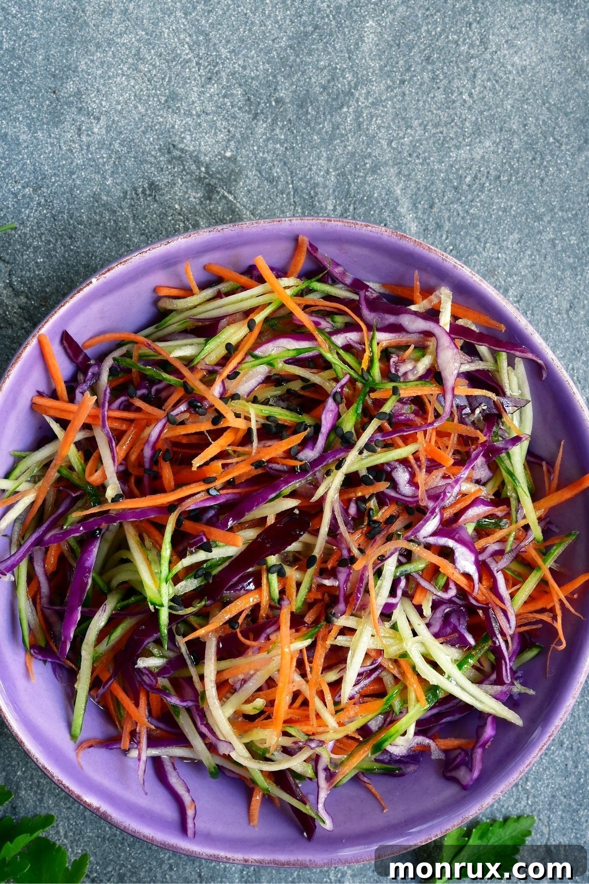 A fresh salad prominently featuring thinly sliced purple cabbage, adding vibrant color and crunch.