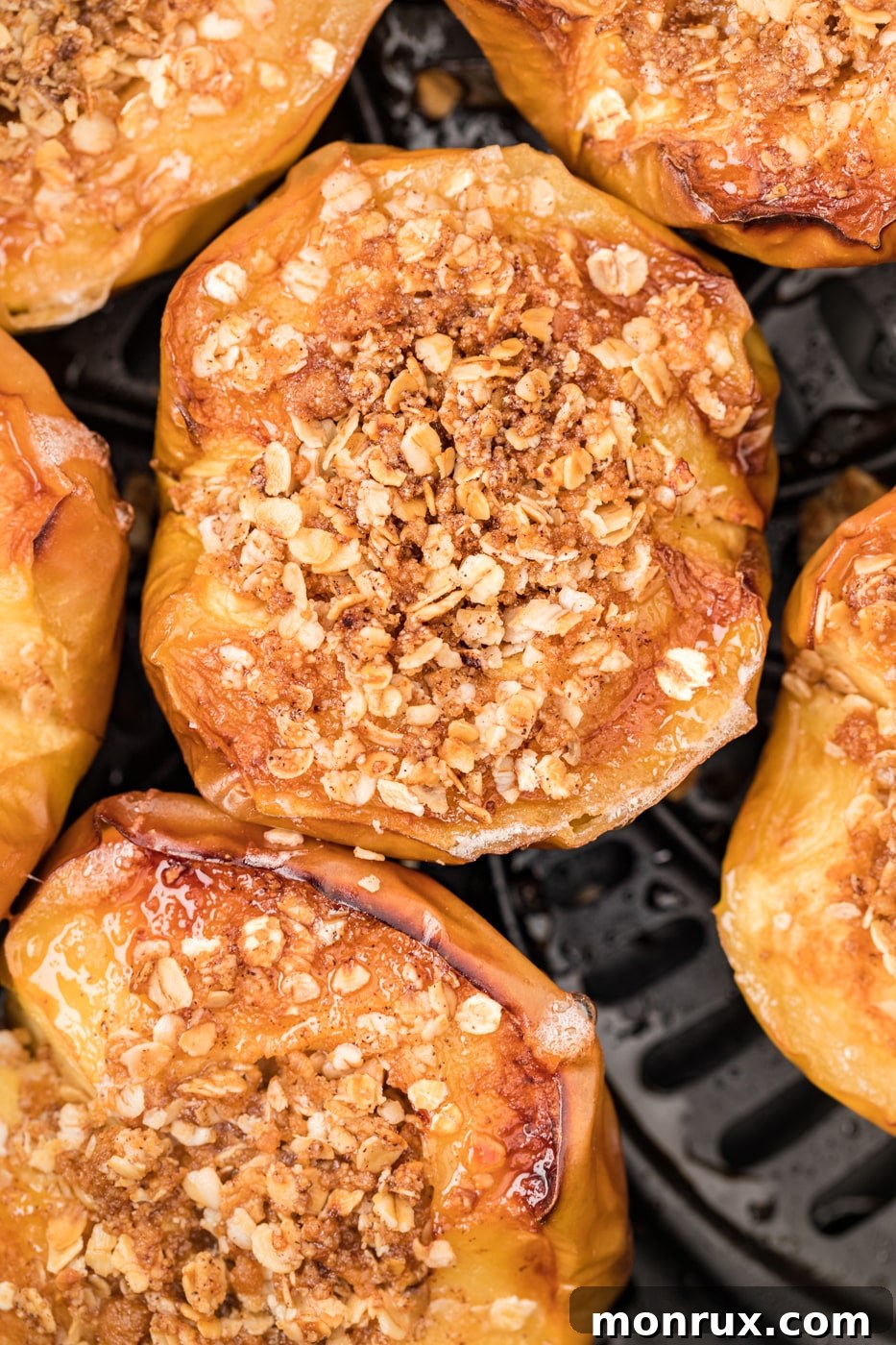 Close-up photo of the texture of air fryer baked apples with a golden oat topping.