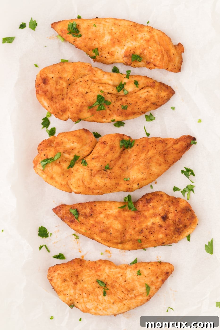 A plate featuring cooked air fryer chicken tenders, golden and juicy, presented for serving.