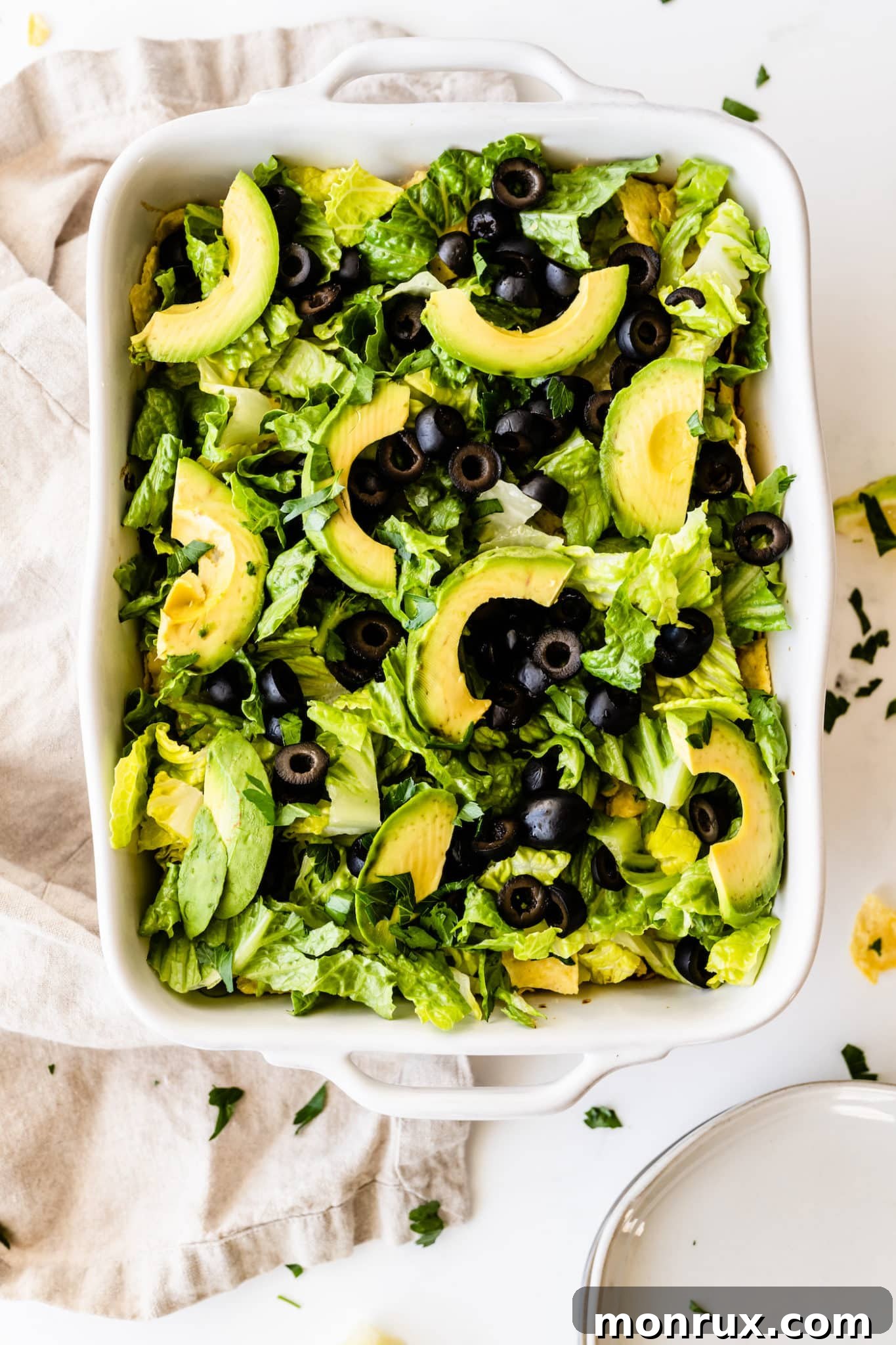 Vegan taco casserole with lettuce, olives, and avocado