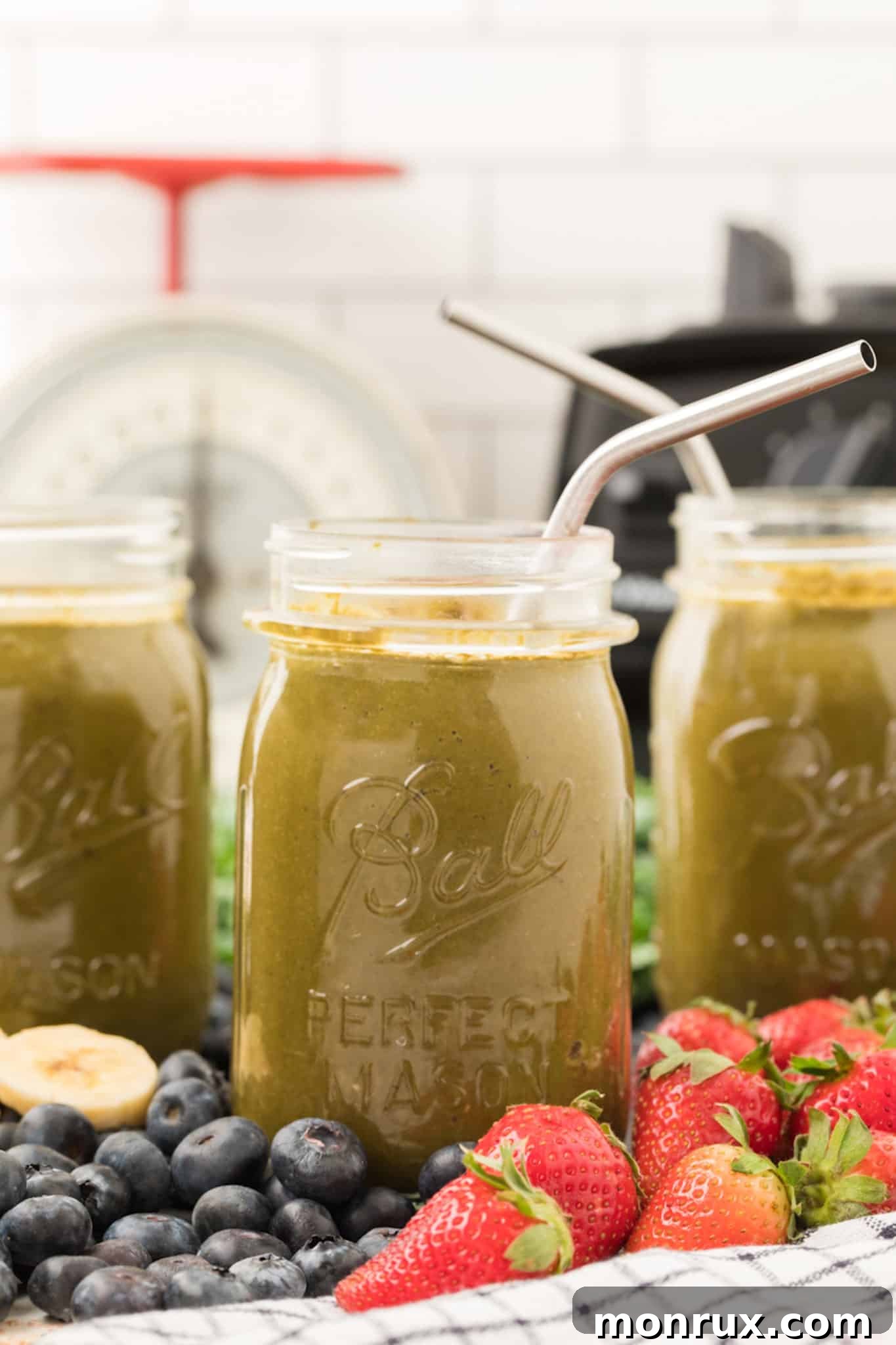 three servings of protein weight loss smoothie with blended kale in three jars.