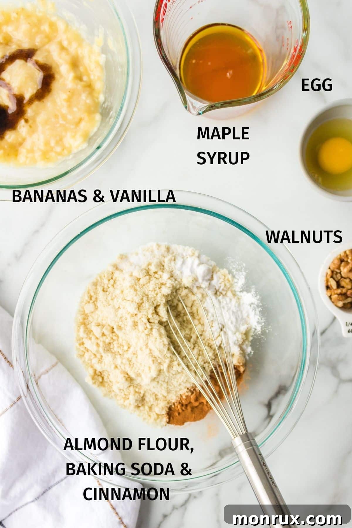 A flat lay photograph showcasing the key ingredients for almond flour banana muffins arranged neatly on a kitchen counter.