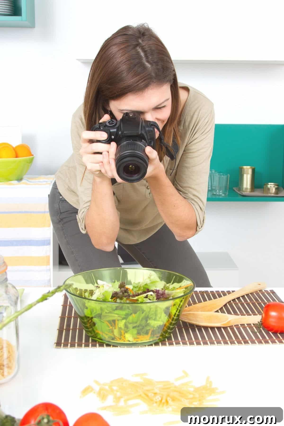 woman taking picture of a vibrant salad prepared with fresh, clean ingredients.