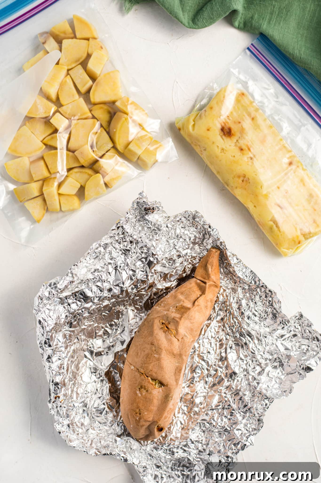 Baked sweet potatoes prepped for freezing whole, diced, or mashed, laid out on a baking sheet.