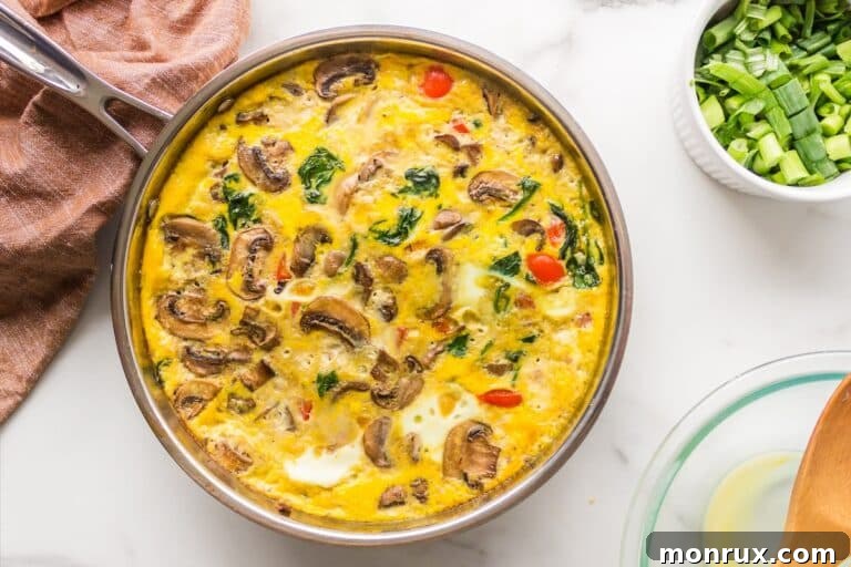 Baked dairy-free frittata in pan, sliced and ready to serve.