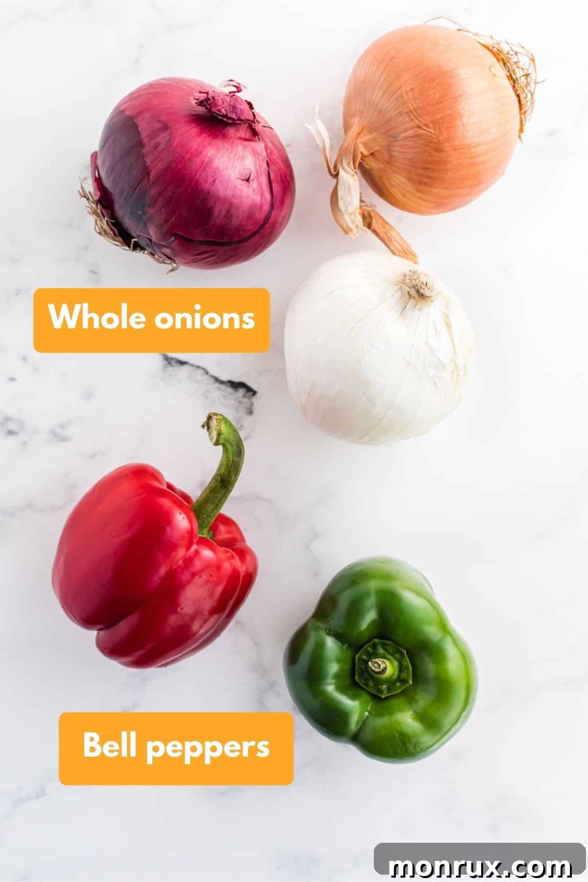 A colorful array of whole onions and bell peppers, ready for preparation.