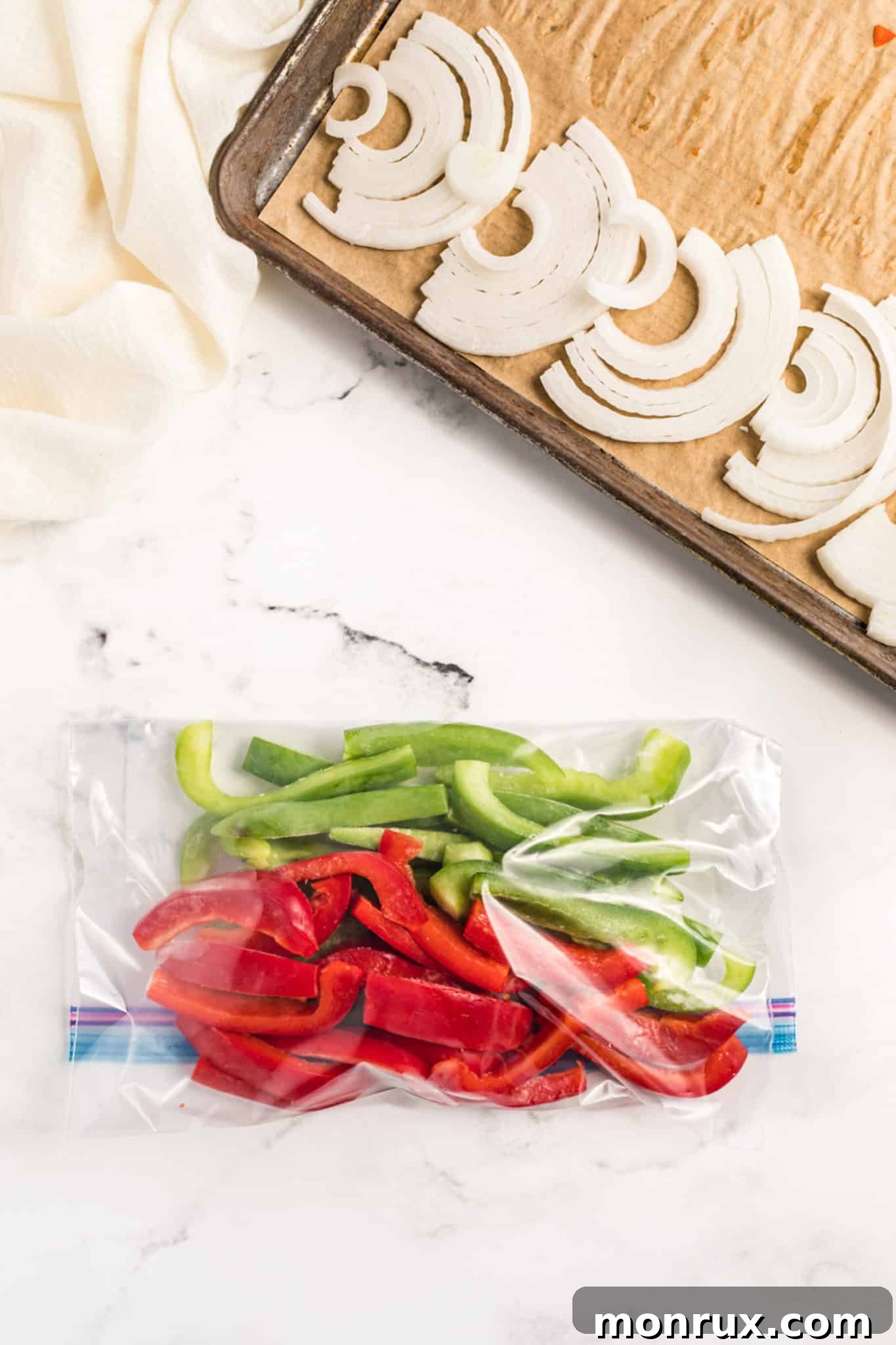 A clear freezer bag filled with bright, sliced bell peppers, securely sealed.
