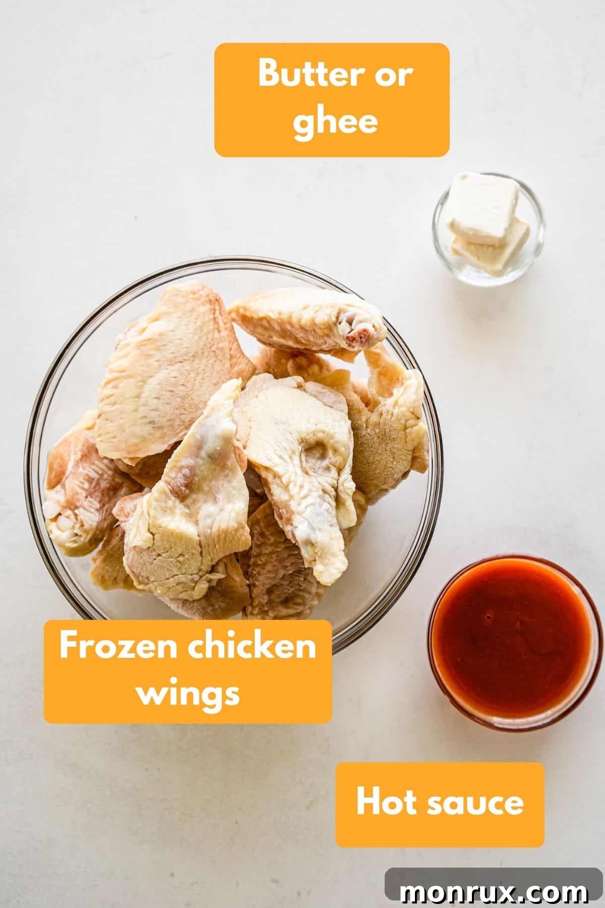 Ingredients for air fried chicken wings and buffalo sauce including frozen chicken wings, butter, and hot sauce.