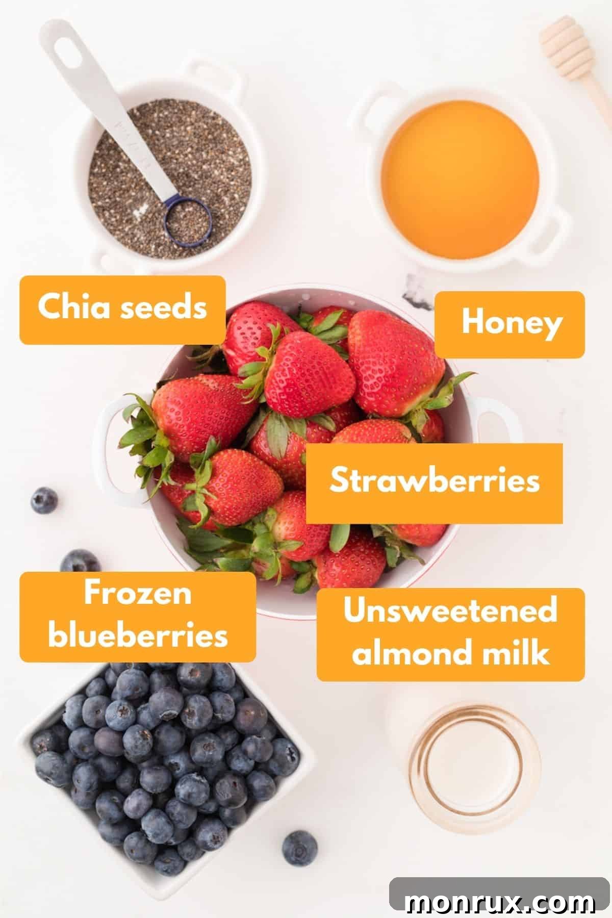Assortment of fresh and frozen ingredients for making a strawberry blueberry smoothie.