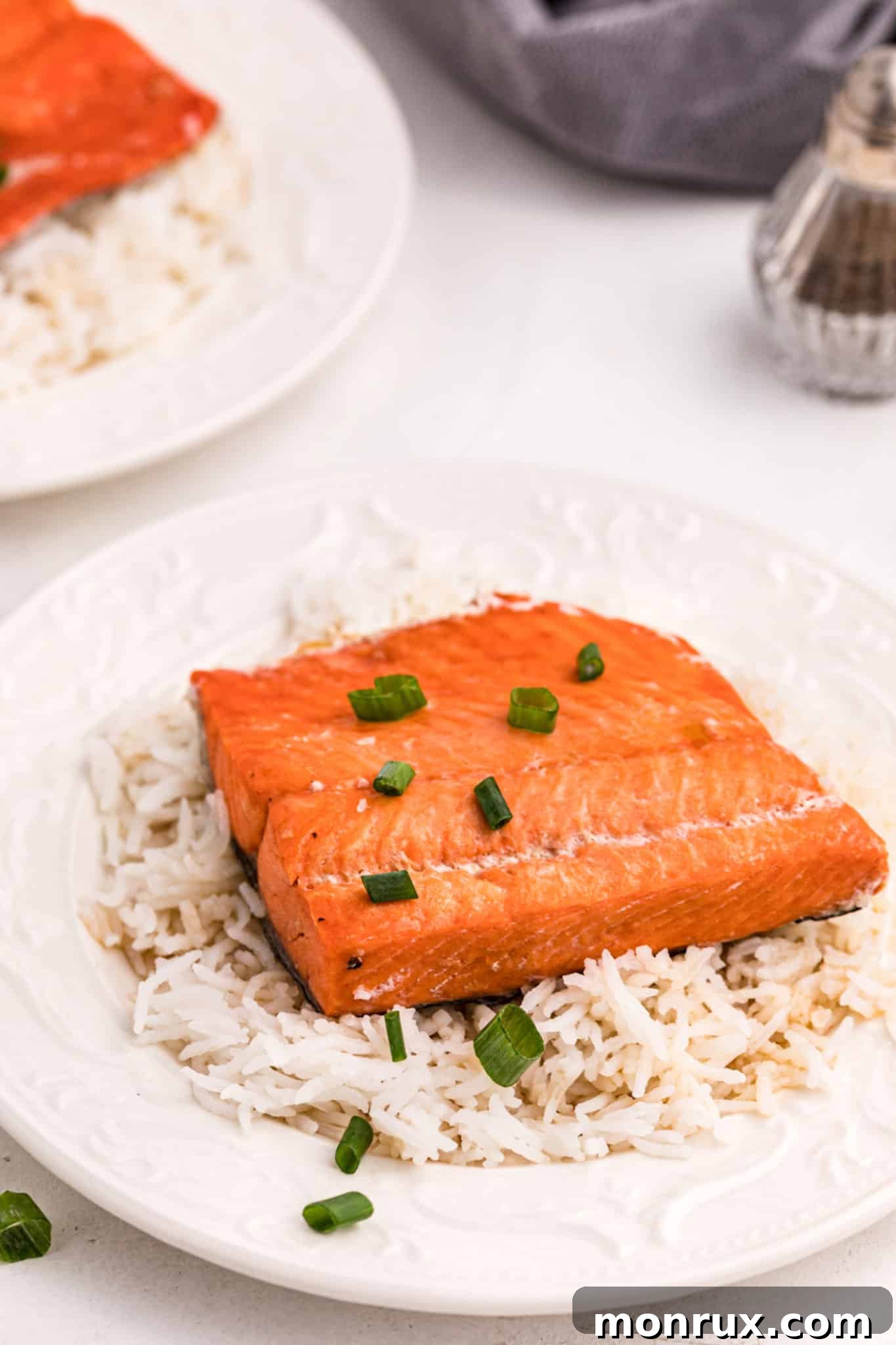 Delicious Instant Pot Teriyaki Salmon and Rice, ready to serve, garnished with fresh herbs.