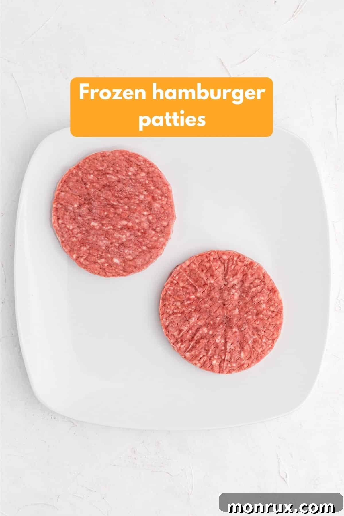 frozen hamburger patties on a platter ready for air fryer.