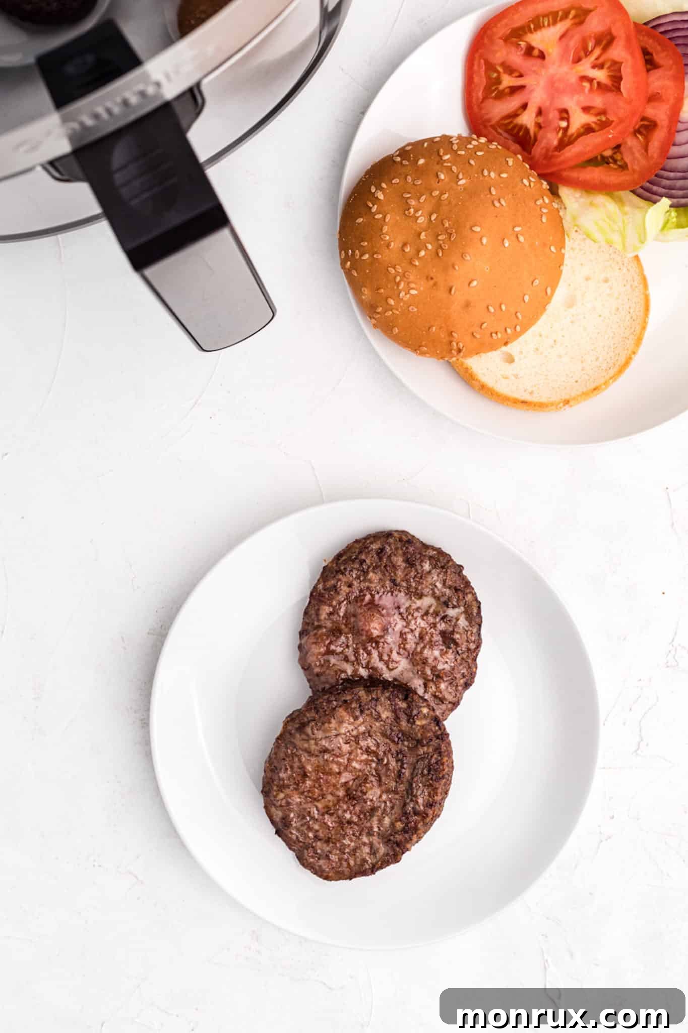 photo with cooked burgers, buns, and toppings ready to be assembled.