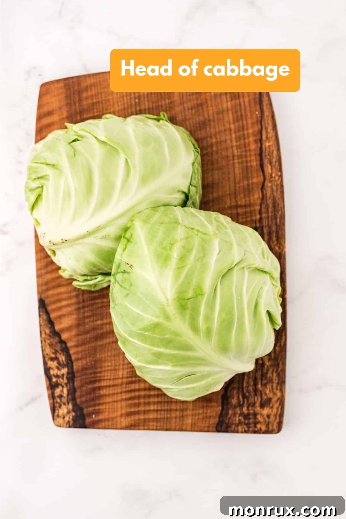 A head of fresh green cabbage, ready for preparation.
