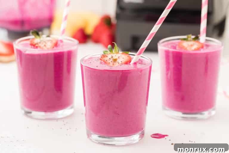 Two dragon fruit smoothies served in glasses, ready to drink.