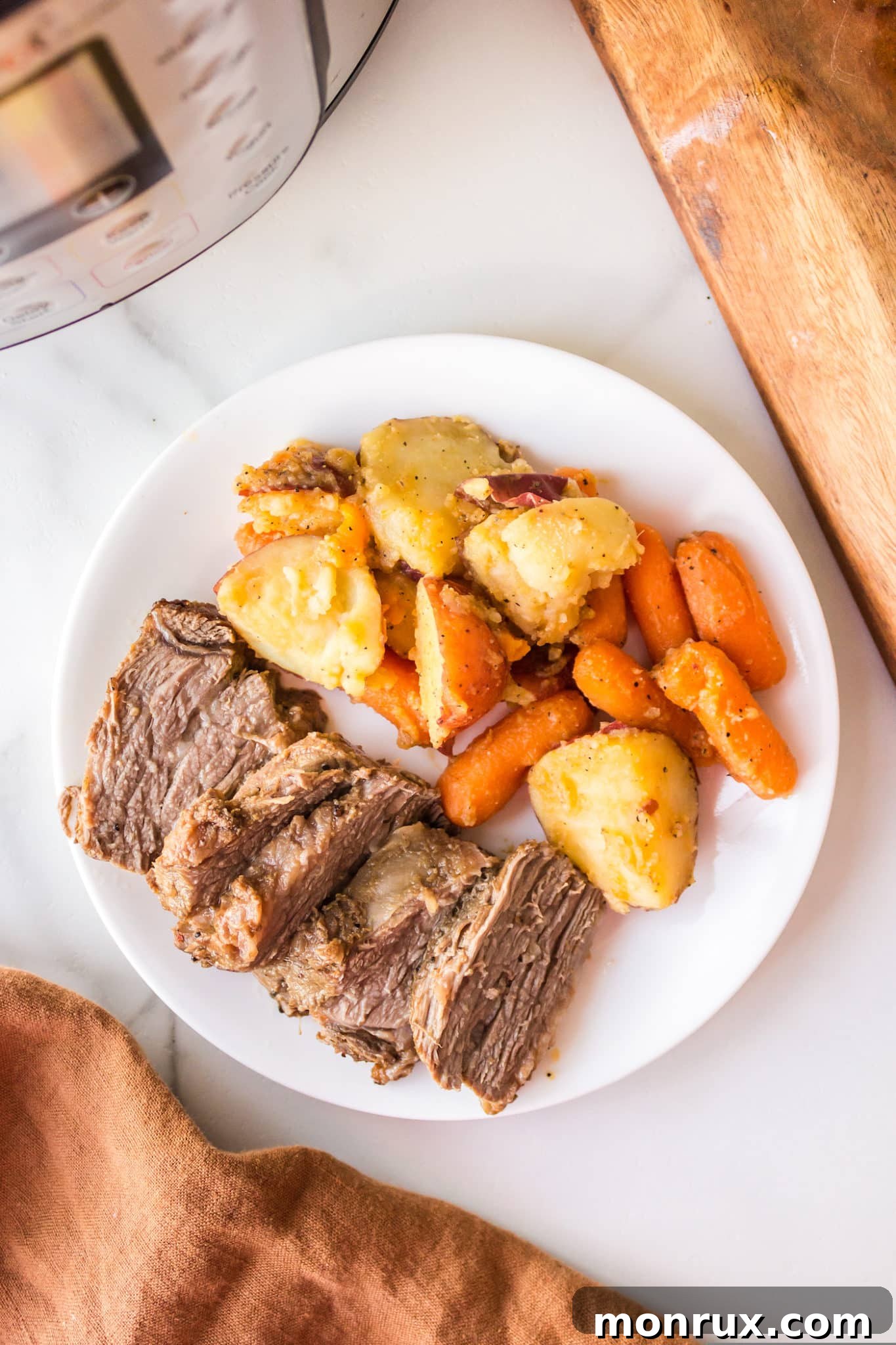 Instant Pot Tri-Tip with roasted potatoes and carrots, ready to serve.