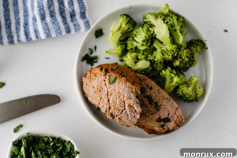 Pork loin roast served with a vibrant side of broccoli, a complete and healthy meal.