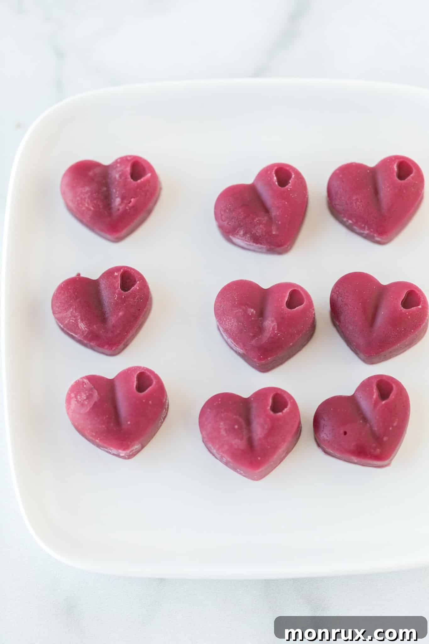 plate with pink heart-shaped vegan gummies.