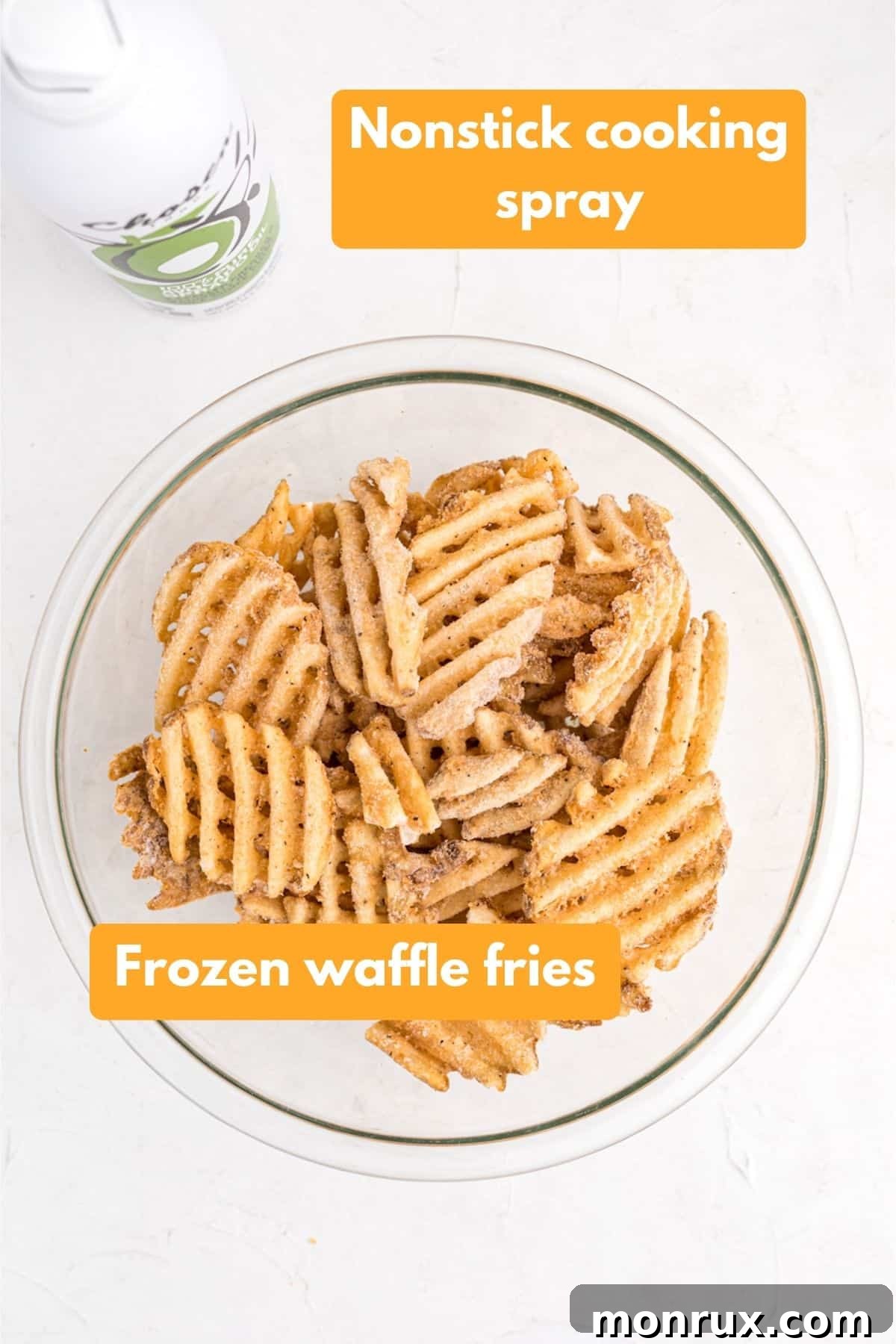 Essential ingredients laid out for air frying waffle fries: a bag of frozen fries and cooking oil spray, highlighting simplicity.