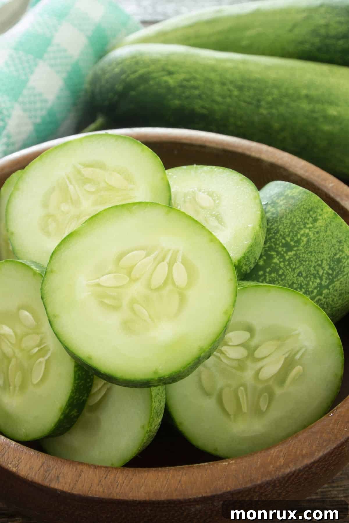 Freshly cut cucumber slices arranged neatly in a bowl, showcasing their refreshing green hue and readiness for snacking.