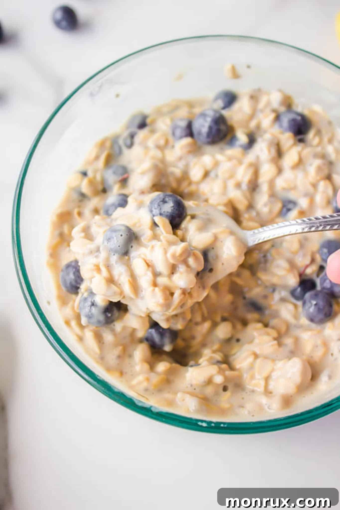 A comforting bowl of overnight oats adorned with fresh blueberries, symbolizing a healthy and convenient breakfast or snack.