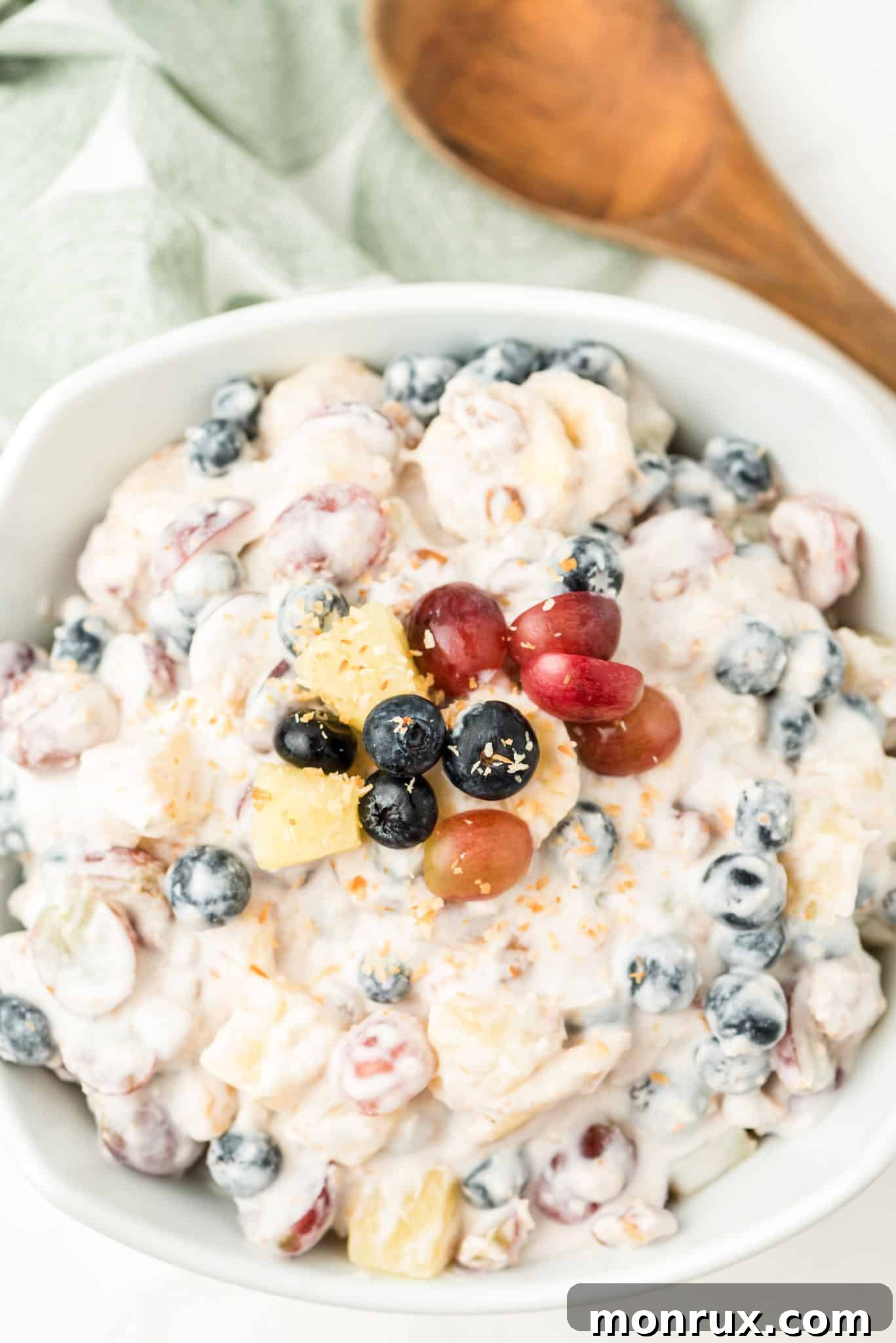 A vibrant ambrosia salad made with fresh fruit, showcasing a healthy and visually appealing snack or dessert.