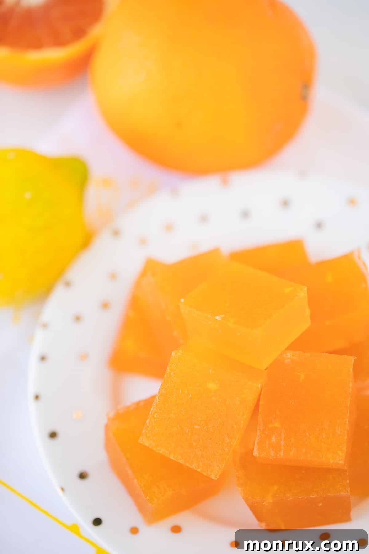 A vibrant bowl of homemade orange jello, set on a rustic table, highlighting its fresh and wholesome ingredients.