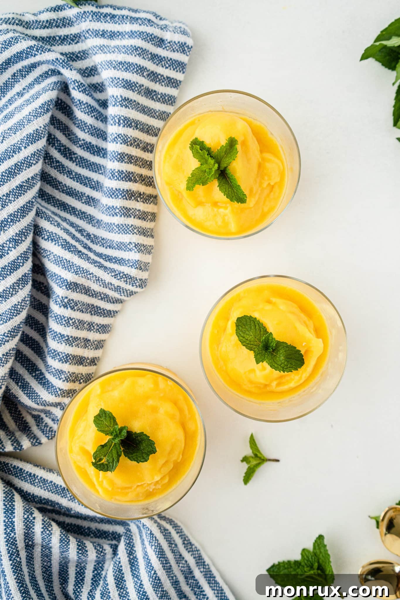 Two glasses of freshly made, creamy mango sorbet, ready to be enjoyed.