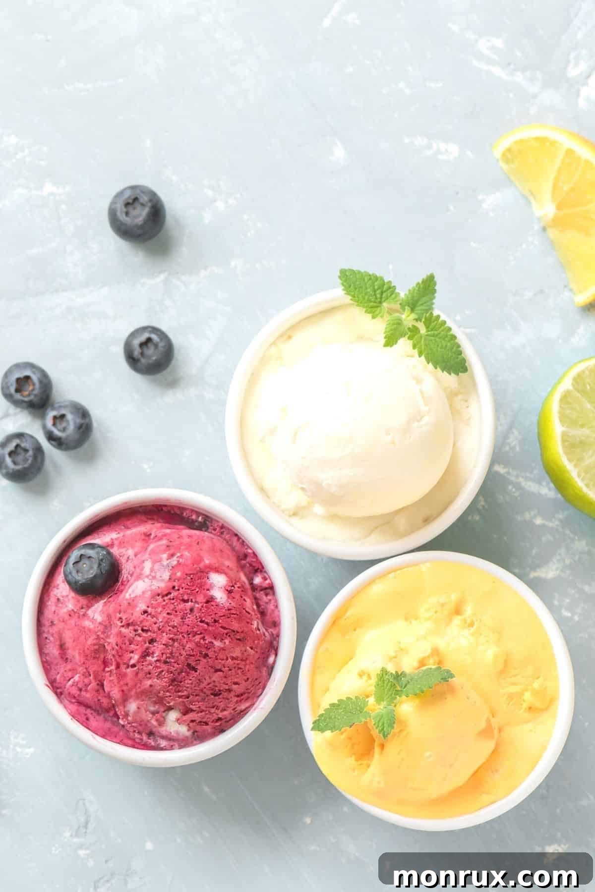 A variety of colorful Vitamix fruit sorbets in bowls, showcasing strawberry, mango, and mixed berry flavors.