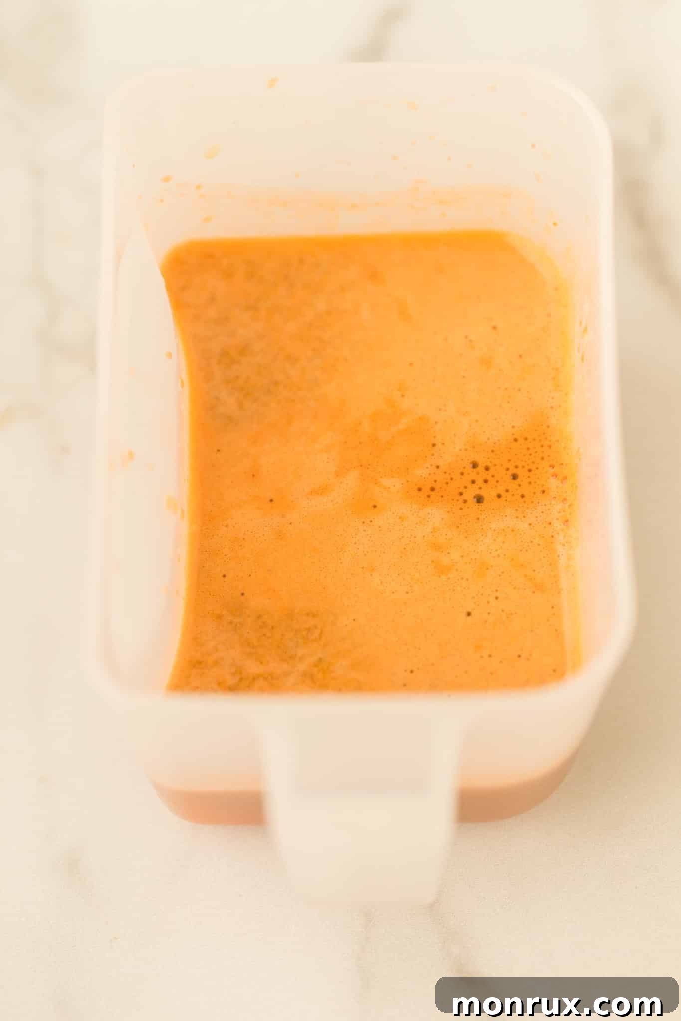 A glass of fresh carrot and cucumber juice, ready to be enjoyed.