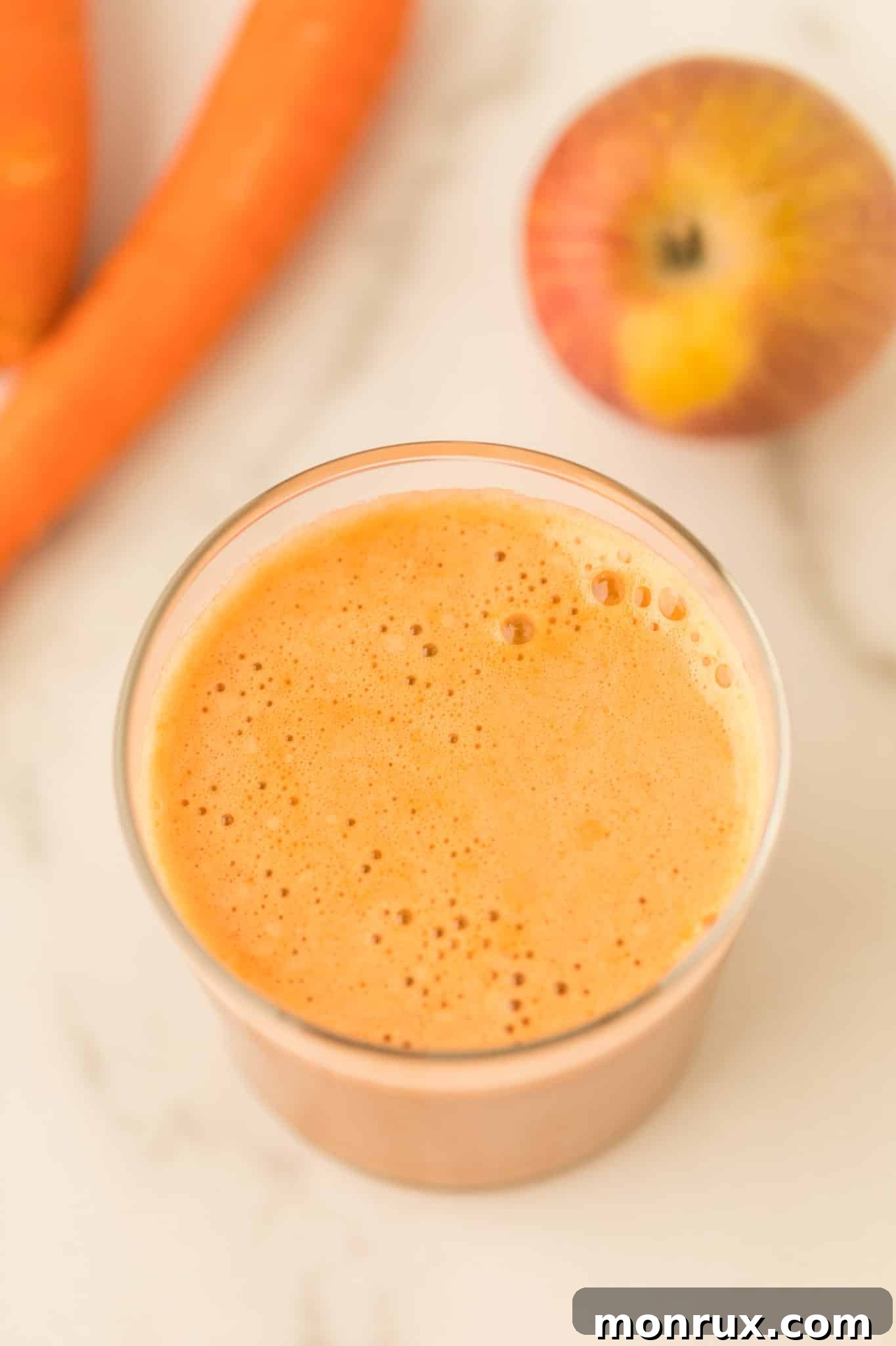 Close-up of a glass of refreshing carrot juice, ready for a healthy sip.
